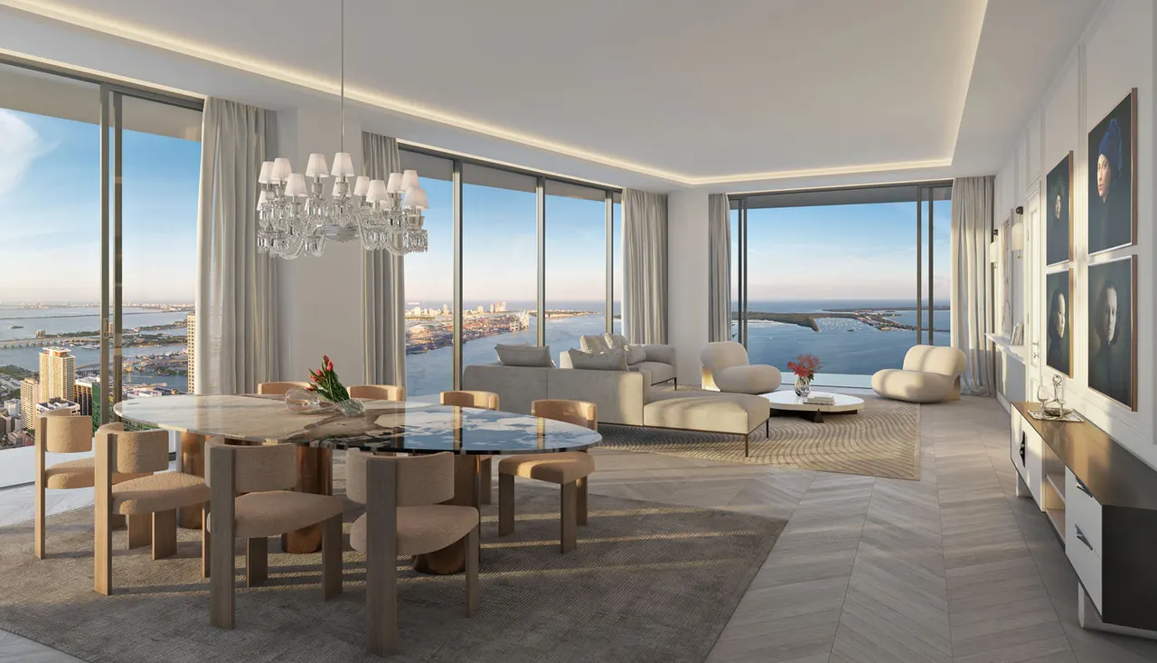 Open living and dining area with floor-to-ceiling windows framing water and city views