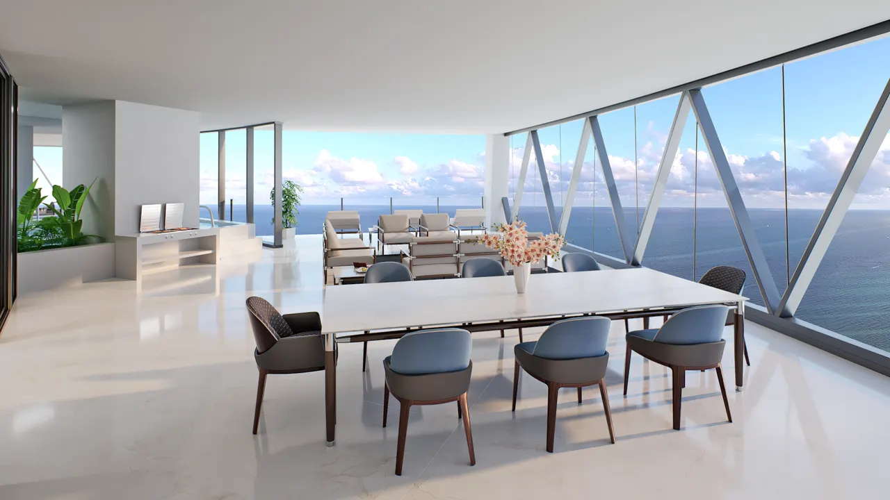 Open dining and living area with floor-to-ceiling glass framing a wide ocean view