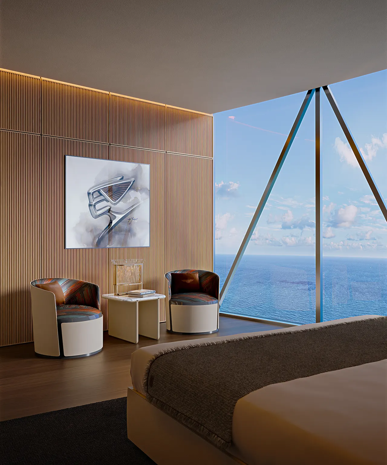 Bedroom with slatted wood wall, two swivel armchairs and floor-to-ceiling glass framing the ocean
