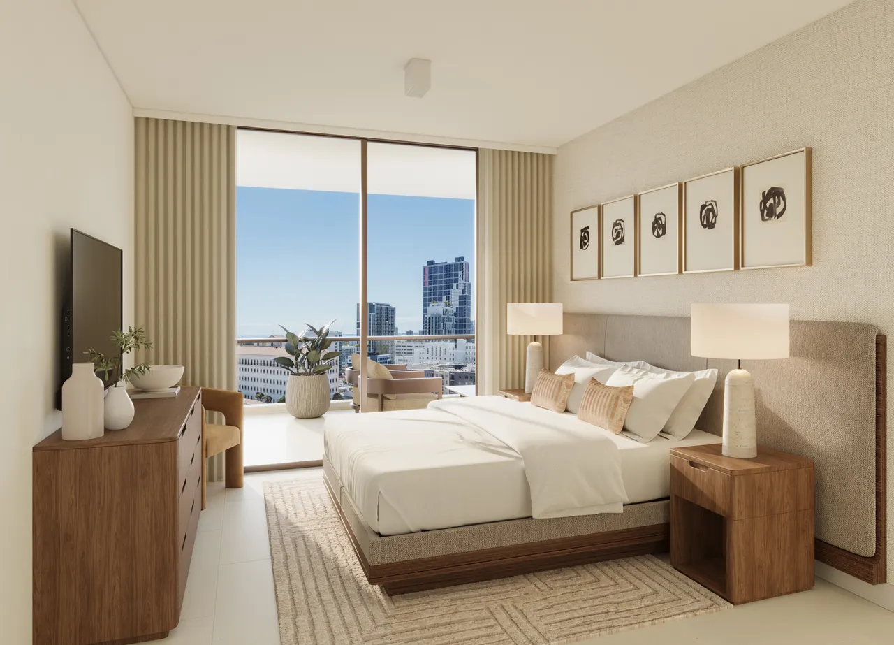 Primary bedroom with upholstered headboard, wood nightstands and floor-to-ceiling window facing the skyline