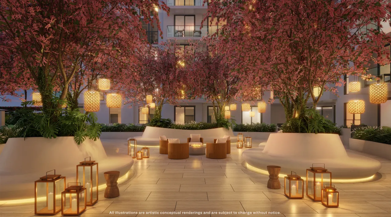 Landscaped courtyard lounge at dusk with hanging lanterns, flowering trees and built-in seating