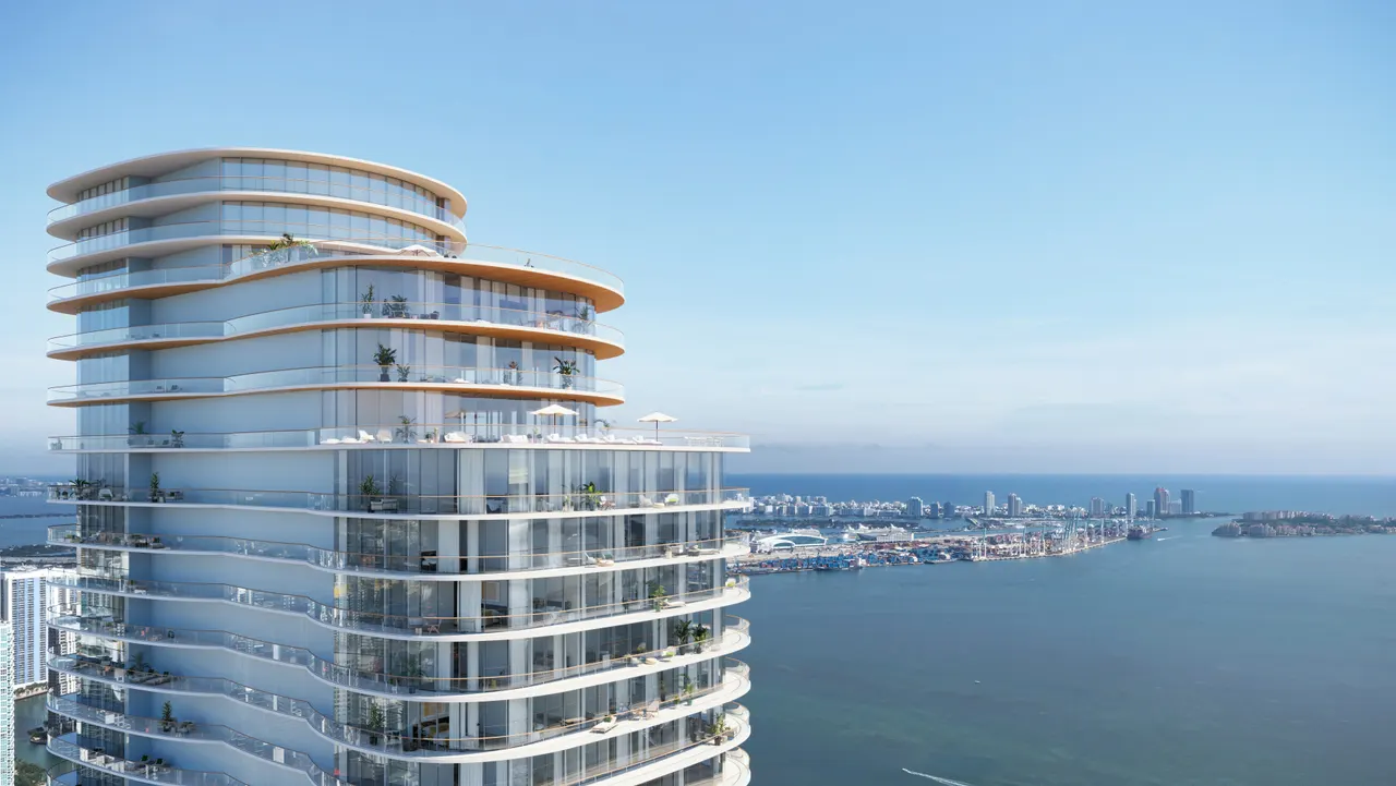 Curved glass tower crown with rooftop terraces and planted balconies above the waterfront