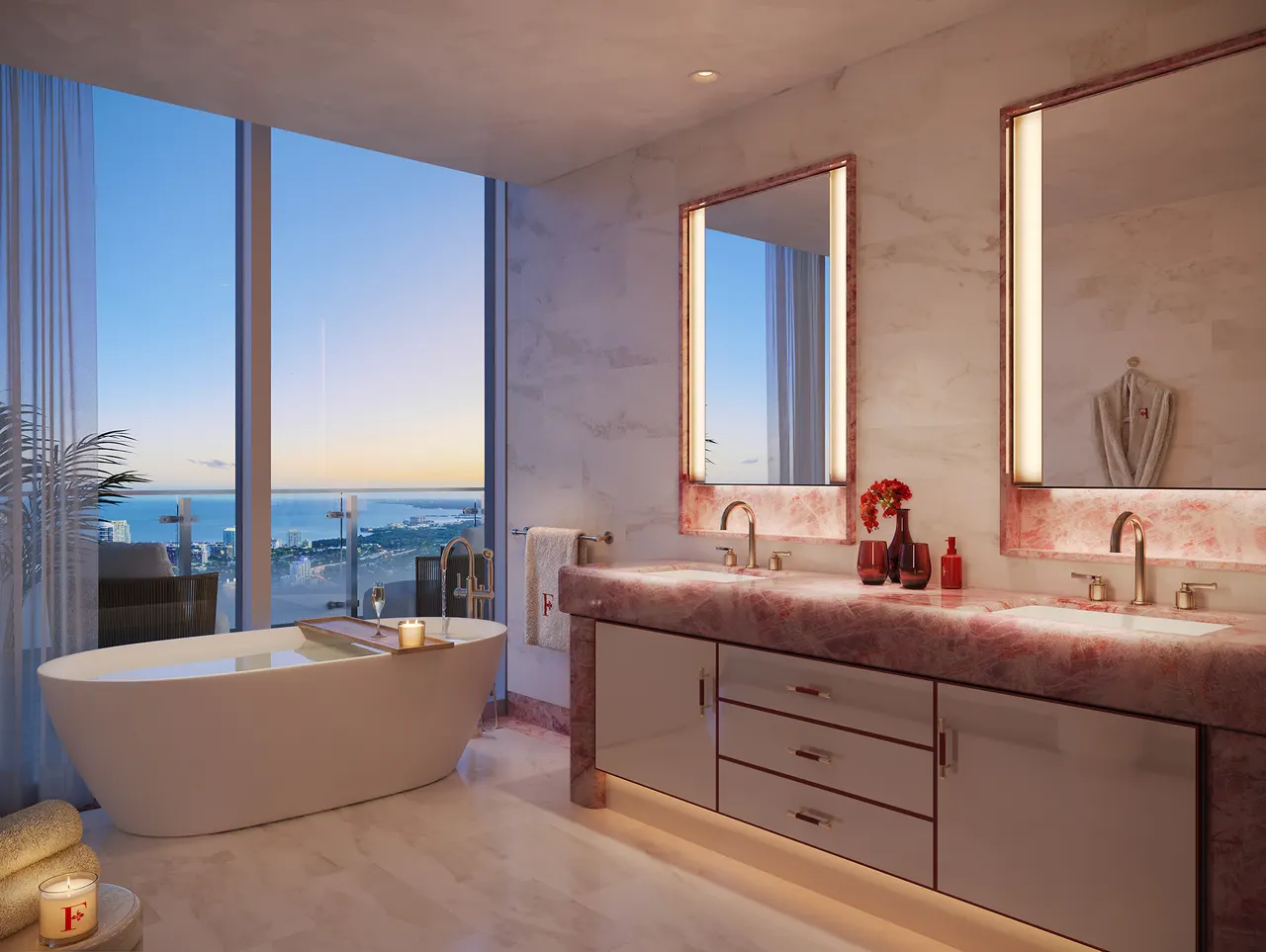 Primary bath with freestanding tub, rose stone double vanity and floor-to-ceiling water views