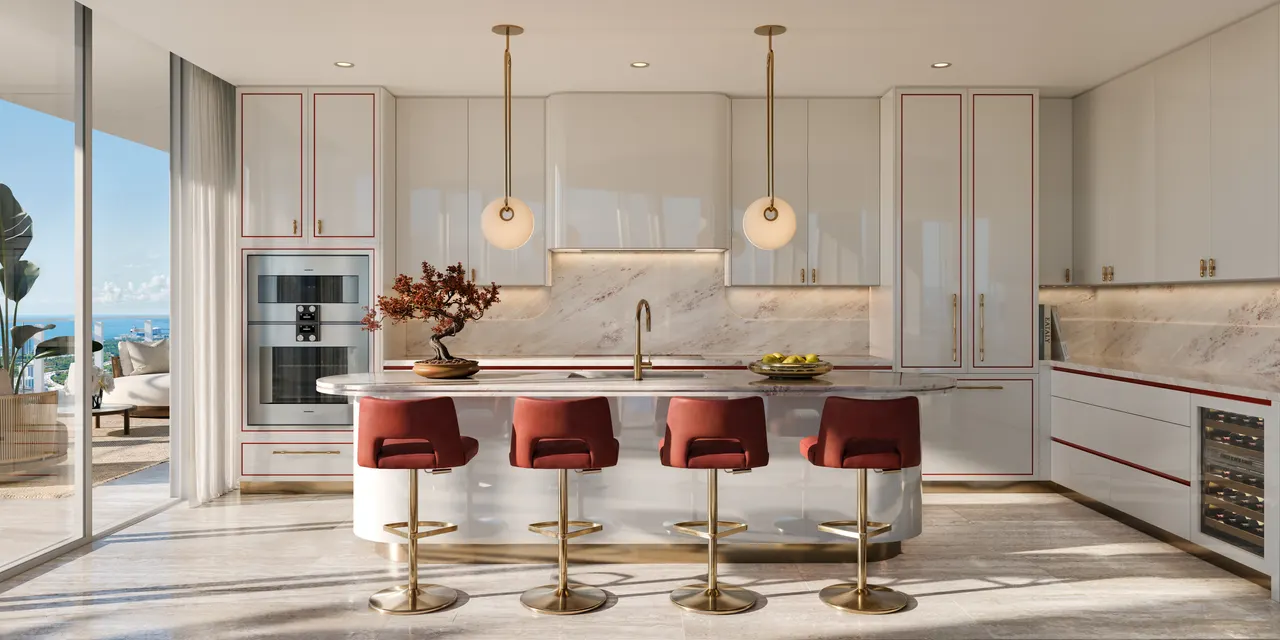 Kitchen with glossy white cabinetry, gold accents and a curved island with red velvet stools