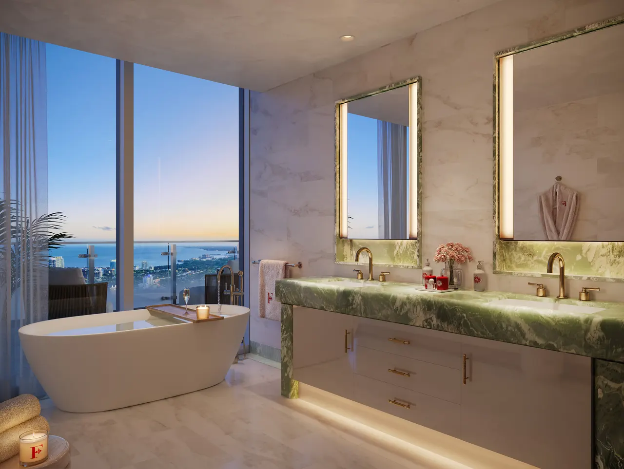 Primary bath with freestanding tub, green marble double vanity and floor-to-ceiling water views