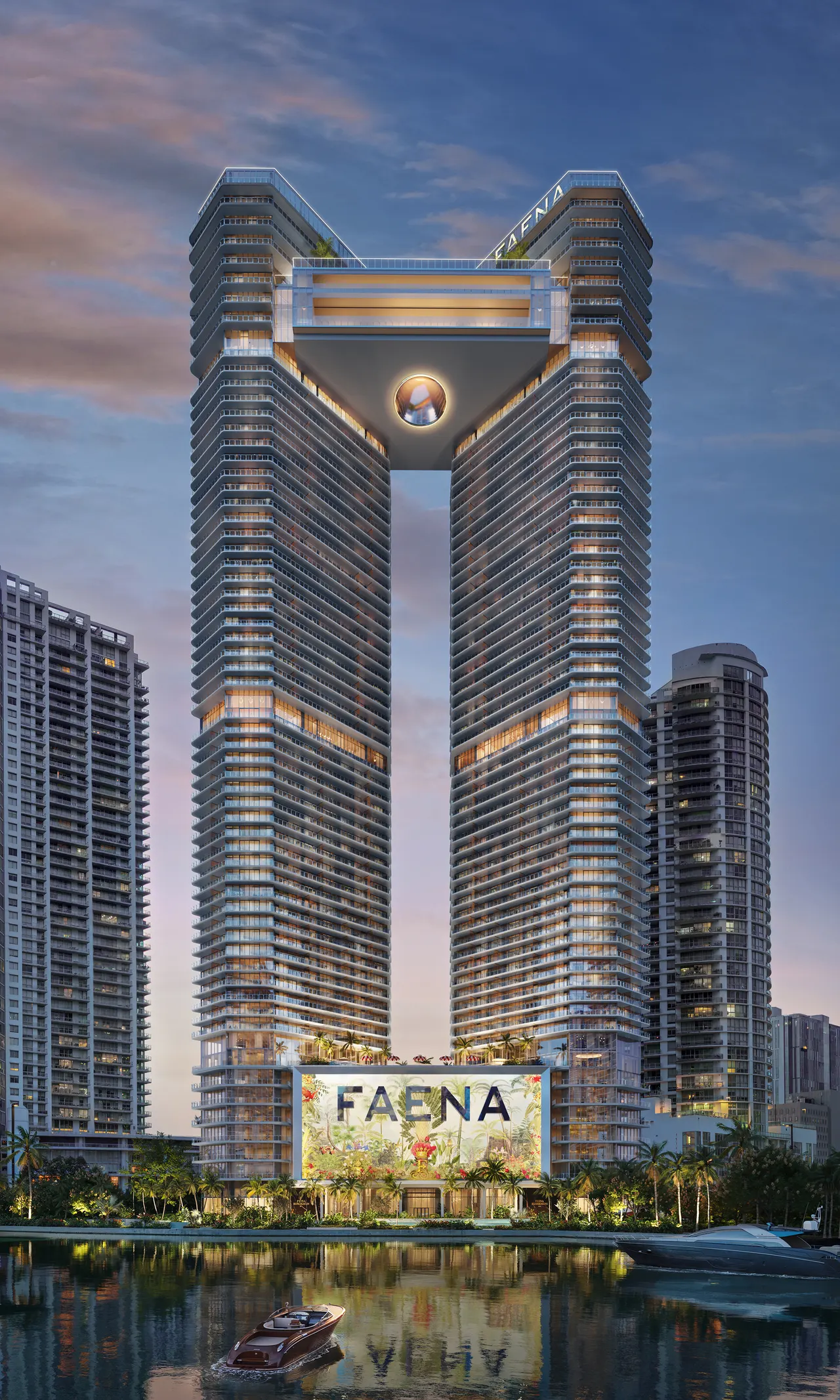 Faena twin towers linked by a sky bridge at dusk, seen from the water with a boat passing