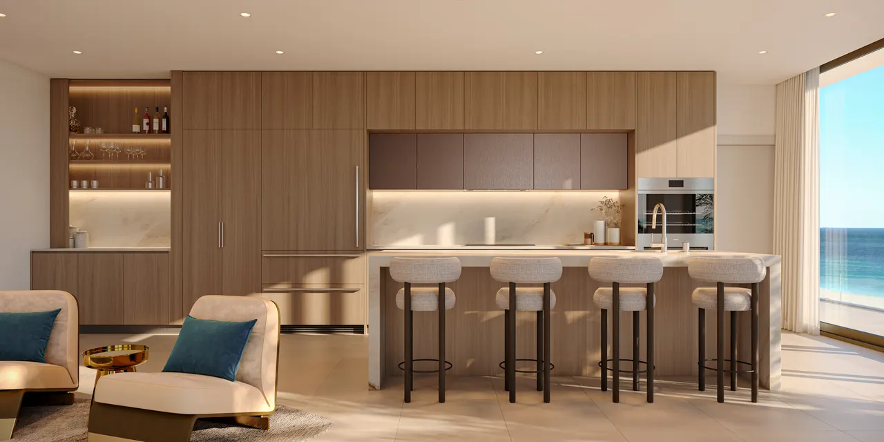 Open kitchen with wood cabinetry, stone island and four barstools beside a window with water view