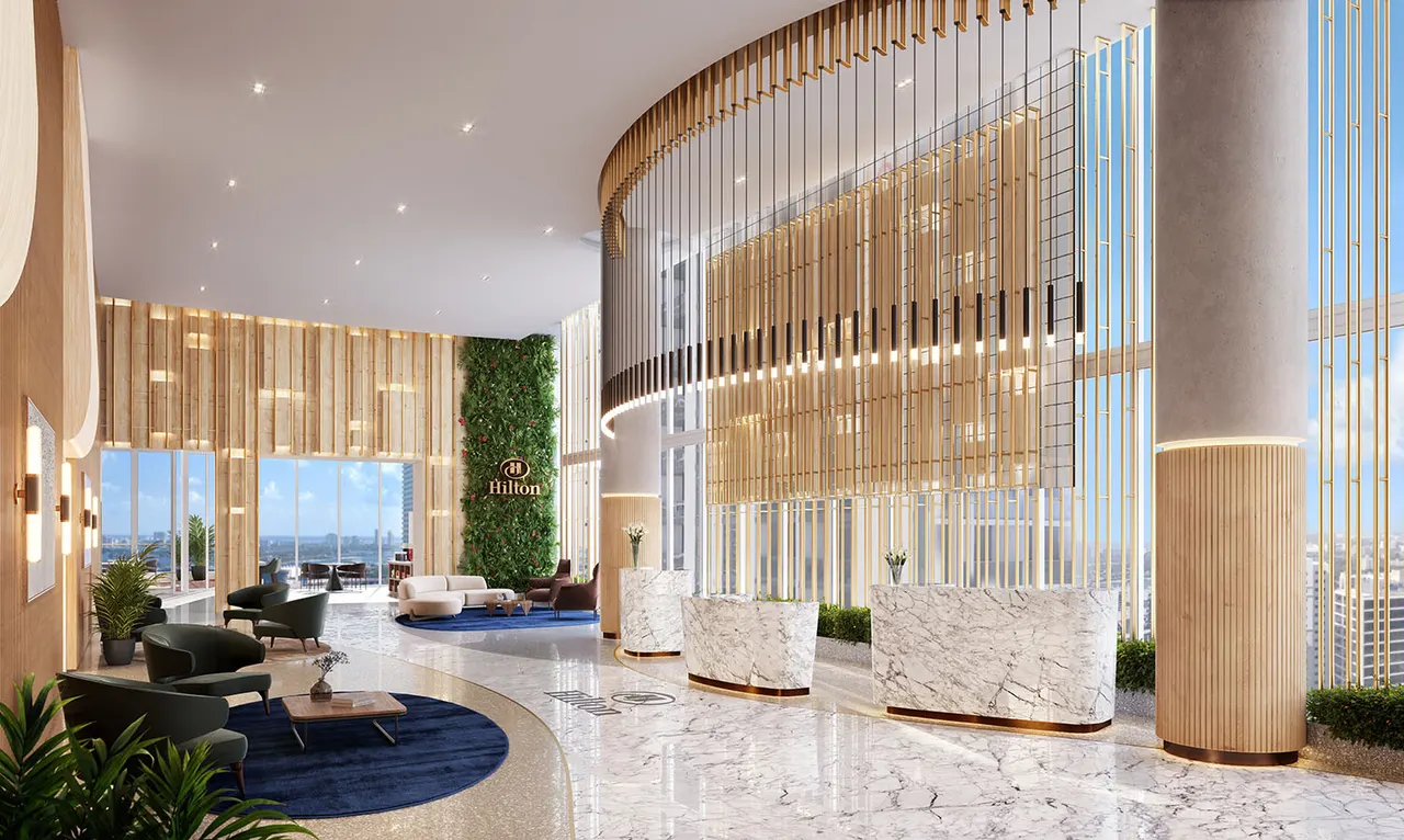 Double-height hotel lobby with marble reception desks, green wall and wood slat ceiling detail