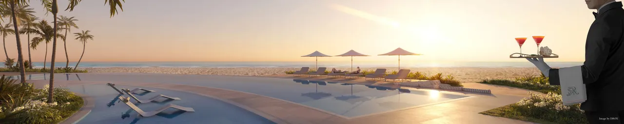 Oceanfront pool deck with sun loungers, umbrellas and a server carrying cocktails at sunset
