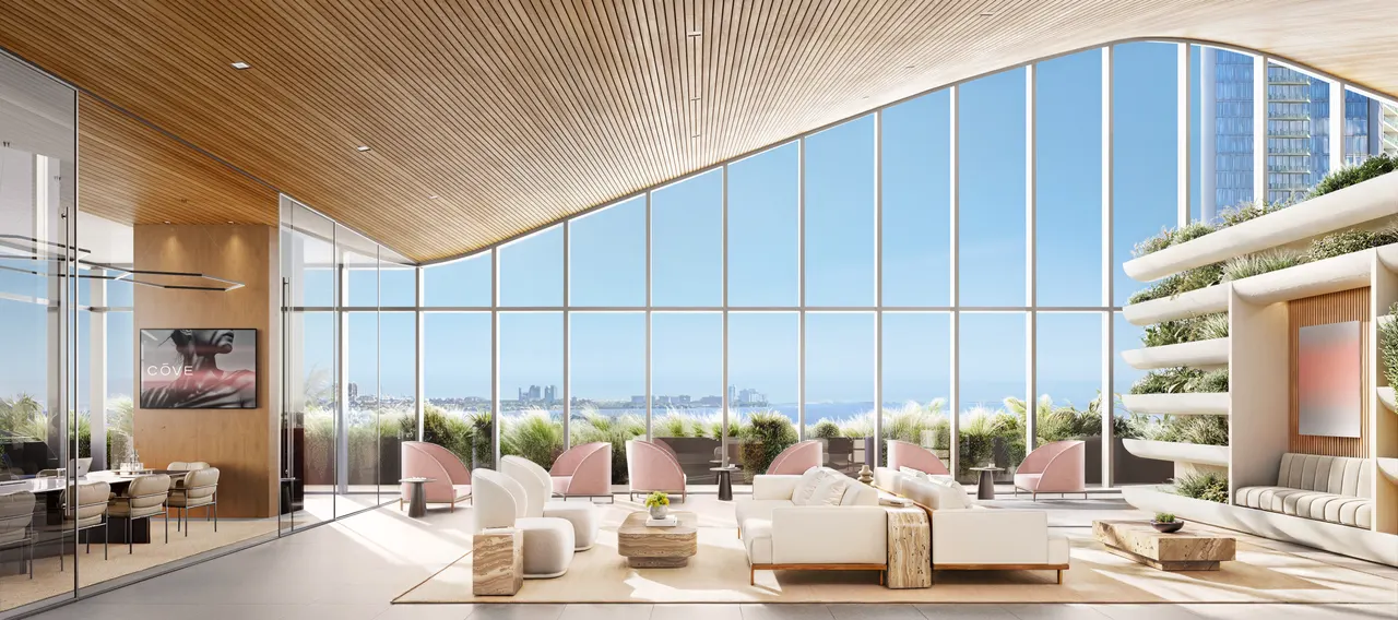 Double-height lounge with curved wood ceiling, floor-to-ceiling glass and water views beyond