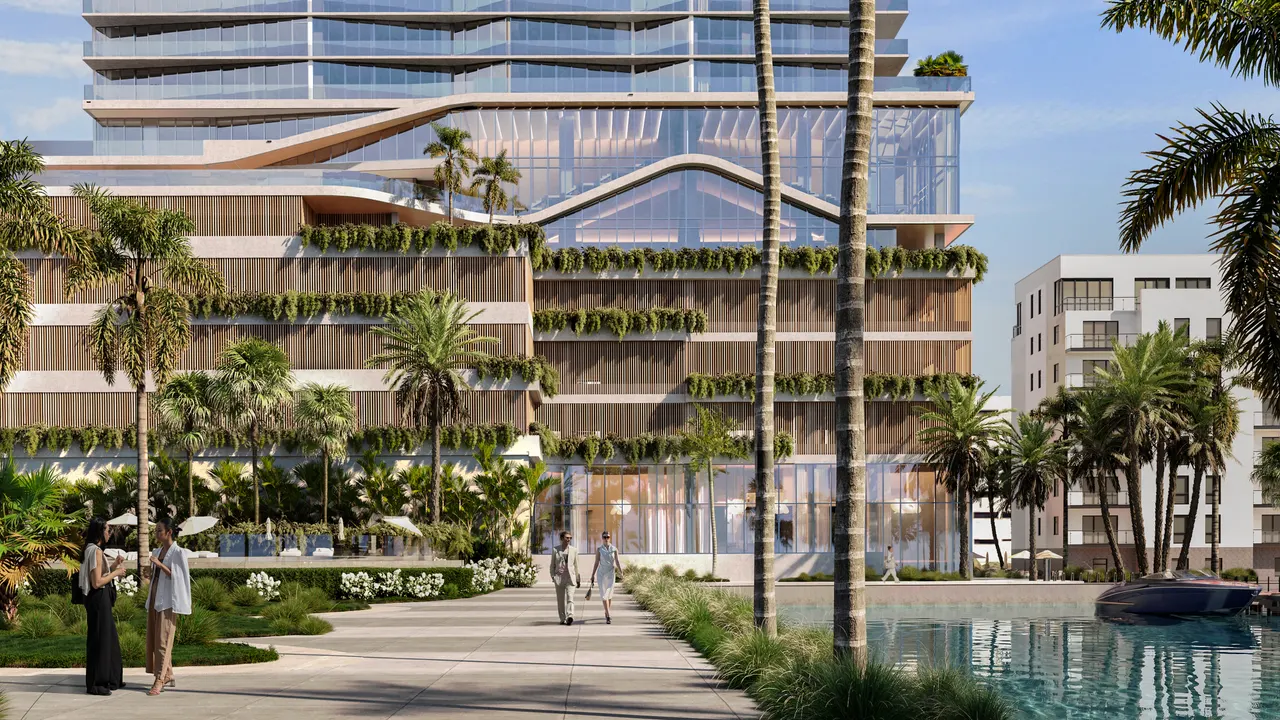 Waterfront tower base with wood-slat facade, planted terraces and a landscaped promenade by the water