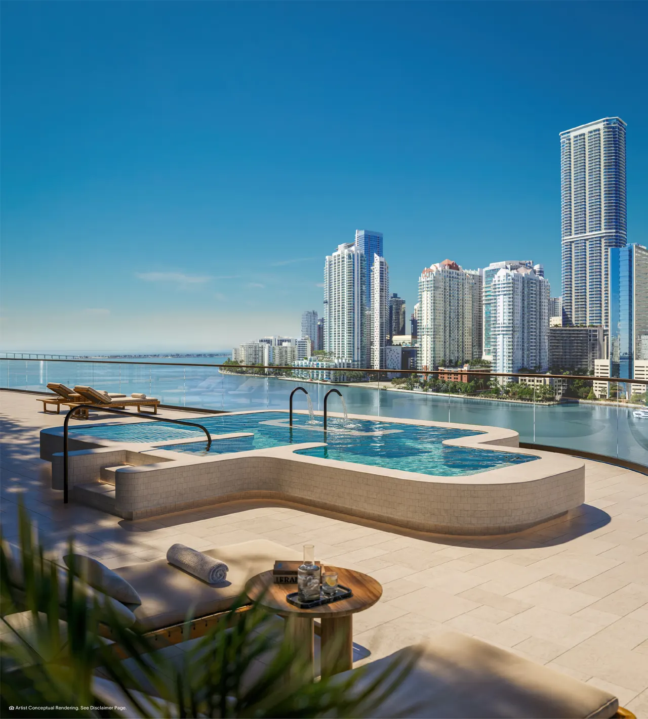 Rooftop vitality pool with sun loungers and water jets overlooking the water and city skyline