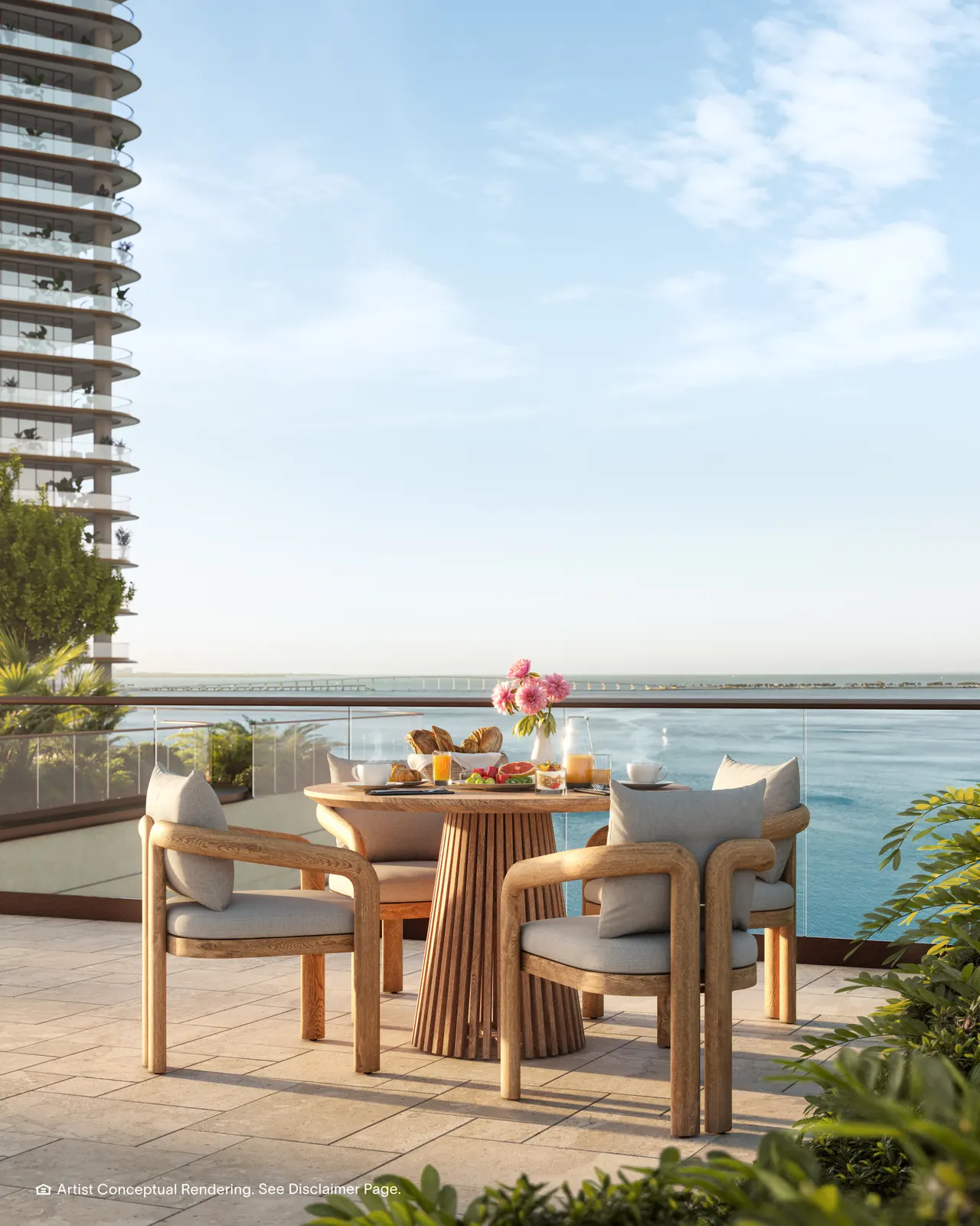 Terrace dining set with breakfast served, glass railing and open water view beyond