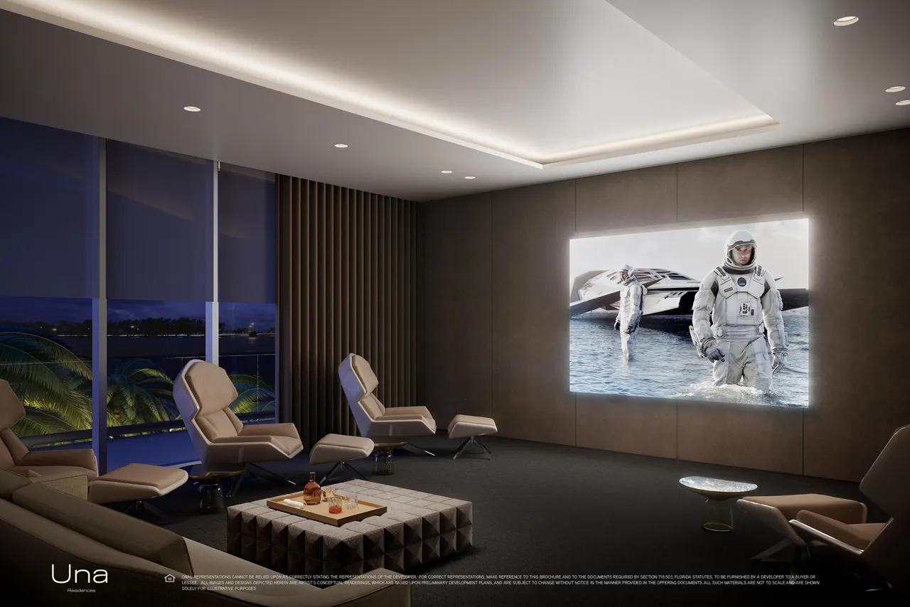 Private screening room with reclining lounge chairs, backlit screen and floor-to-ceiling windows over the water