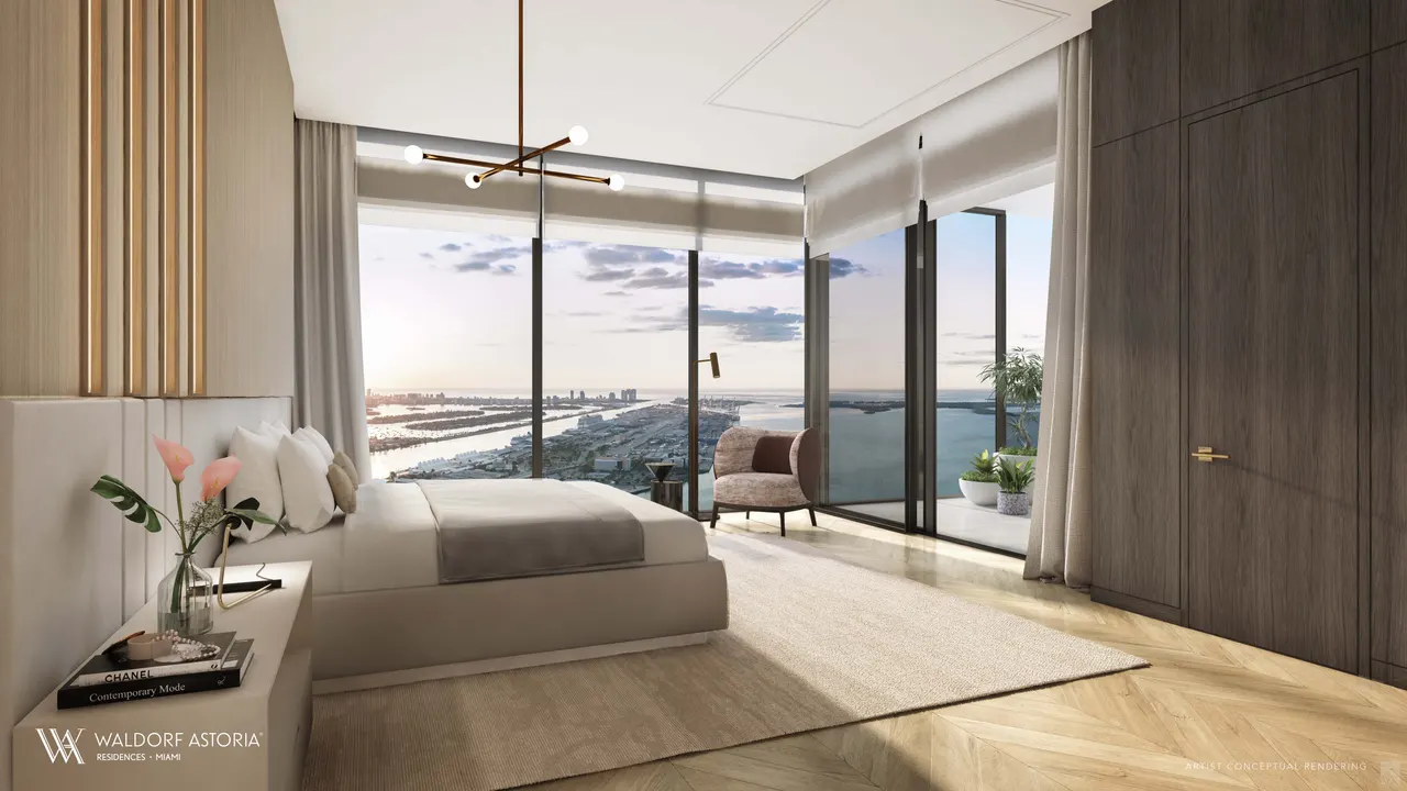 Primary bedroom with floor-to-ceiling glass, water views and a private balcony beyond