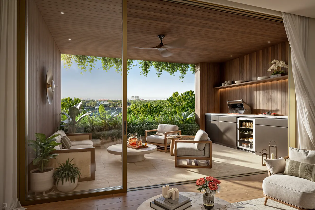 Covered terrace with summer kitchen, grill, lounge chairs and treetop views beyond sliding glass doors