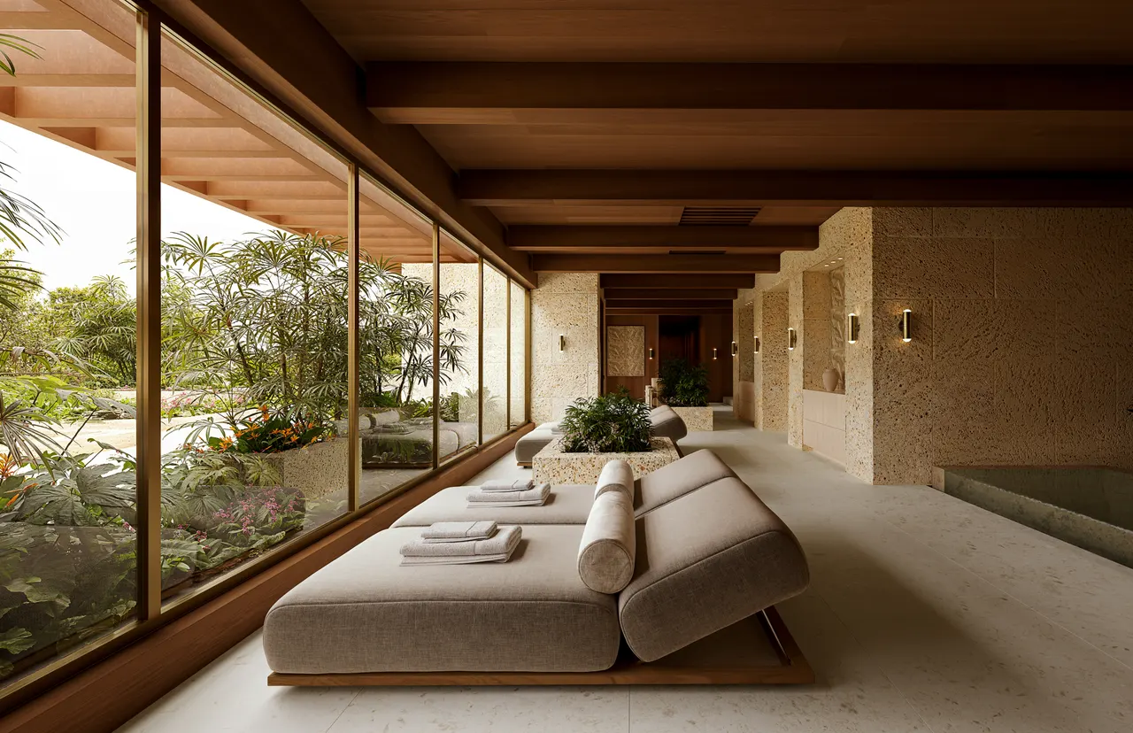 Spa relaxation lounge with daybeds, wood beam ceiling and glass wall onto a tropical garden